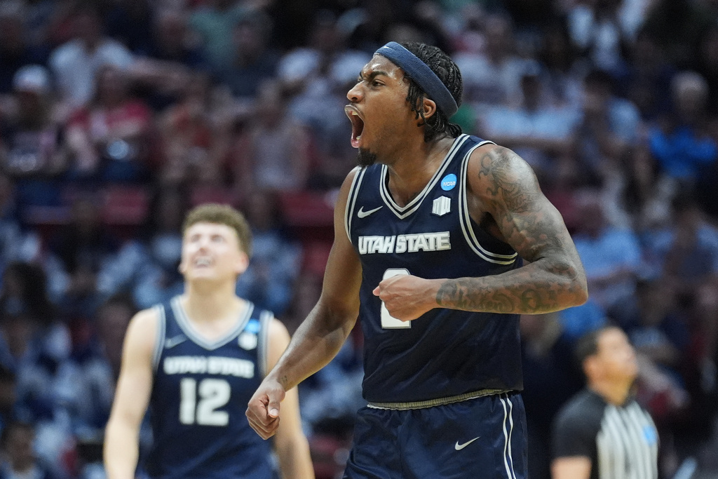 Utah State guard MJ Collins celebrates during the second half in the first round of the NCAA college basketball tournament against Villanova, Friday, March 20, 2026, in San Diego. (AP Photo/Marcio Jose Sanchez)