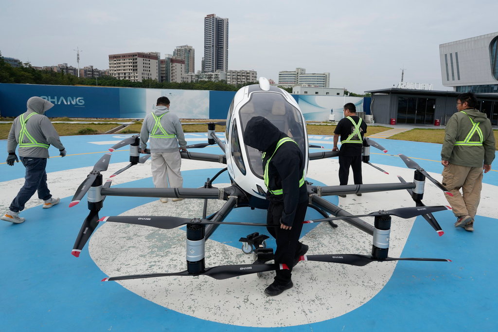 Workers prepare the EHang eVTOL EH126-S to fly in Guangzhou in southern China's Guangdong province on Monday, Nov. 3, 2025. (AP Photo/Ng Han Guan)