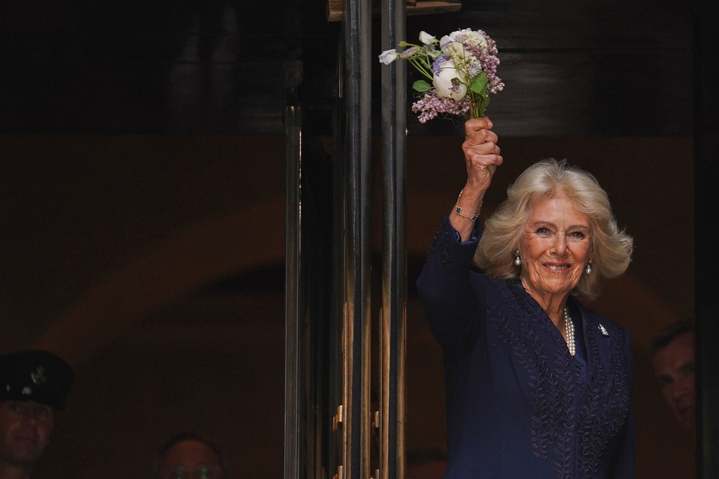 Queen Camilla waves flowers outside the New York Public Library, Wednesday, April 29, 2026, in New York. (AP Photo/Ryan Murphy)