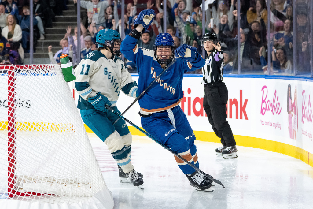 Vancouver Goldeneyes' Gabby Rosenthal (15) celebrates her goal as Seattle Torrent's Emily Brown (11) skates behind during the third period of a PWHL hockey game in Vancouver, on Friday, Nov. 21, 2025. (Ethan Cairns/The Canadian Press via AP)