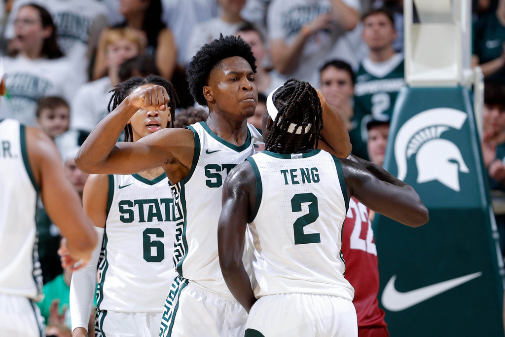 Michigan State forward Cam Ward, center left, and guard Kur Teng (2) celebrate during the first half of an NCAA college basketball game, Monday, Nov. 3, 2025, in East Lansing, Mich. (AP Photo/Al Goldis)
