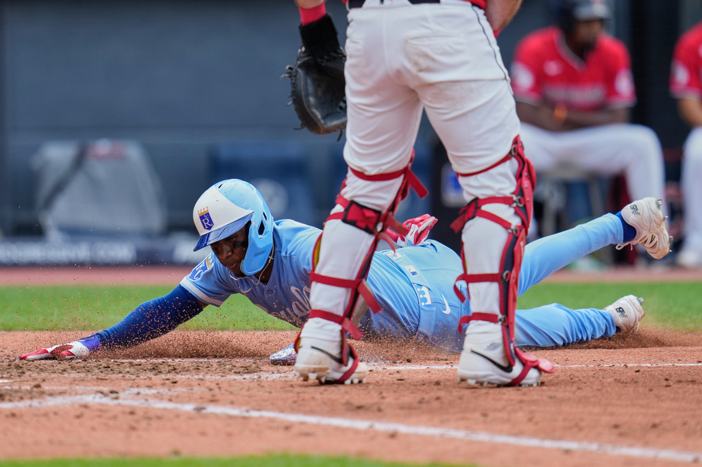 Kansas City Royals' Tyler Tolbert, left, slides safely home behind Cleveland Guardians catcher Austin Hedges on a double hit by Isaac Collins in the fifth inning of a baseball game in Cleveland, Saturday, Aug. 29, 2026. (AP Photo/Sue Ogrocki)