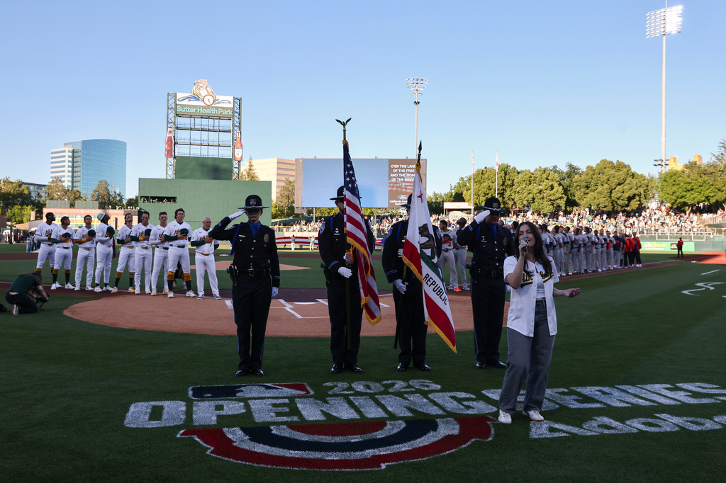 The national anthem is sung before a home-opener baseball game between the Athletics and the Houston Astros, Friday, April 3, 2026, in West Sacramento, Calif. (AP Photo/Sara Nevis)