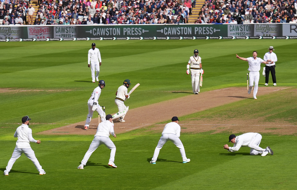 England's Ollie Robinson celebrates the wicket of Pakistan's Abdullah Shafique, caught out by Dan Lawrence, during day one of the third cricket test match between England and Pakistan, at Edgbaston, in Birmingham, England, Wednesday, Sept. 9, 2026. (Mike Egerton/PA via AP)