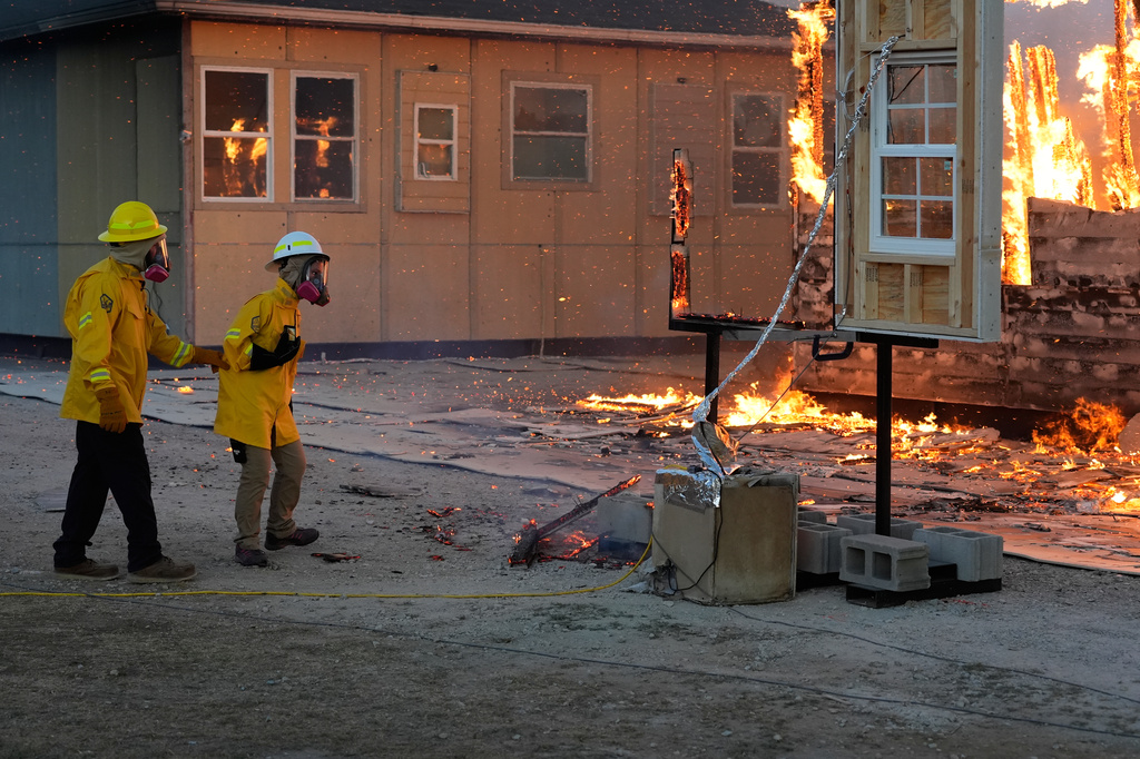 Wildfire researchers watch an accessory dwelling unit burn during an experiment at the Institute for Business & Home Safety center on Thursday, April 16, 2026, in Richburg, S.C. (AP Photo/Erik Verduzco)
