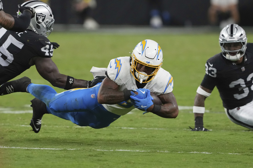 Los Angeles Chargers running back Omarion Hampton (8) dives for a first down against the Las Vegas Raiders during the second half of an NFL football game, Monday, Sept. 15, 2025, in Las Vegas. (AP Photo/Rick Scuteri)