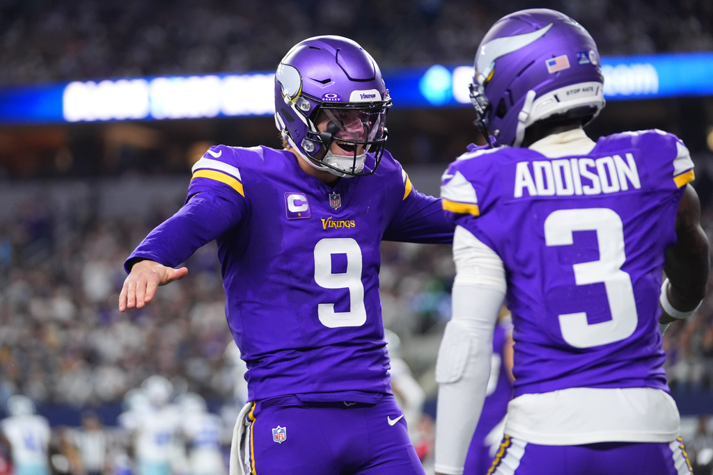 Minnesota Vikings quarterback J.J. McCarthy (9) and wide receiver Jordan Addison celebrate after a touchdown by wide receiver Jalen Nailor during the second half of an NFL football game against the Dallas Cowboys Sunday, Dec. 14, 2025, in Arlington, Texas. (AP Photo/Julio Cortez)