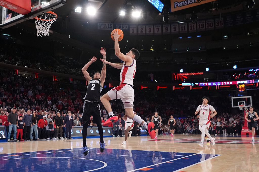 St. John's Red Storm's Dylan Darling (0) drives past Georgetown Hoyas' Malik Mack (2) during the second half of an NCAA college basketball game Tuesday, March 3, 2026, in New York. (AP Photo/Frank Franklin II)