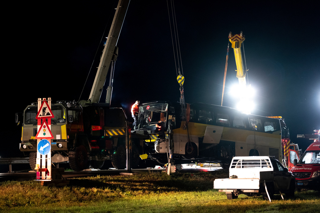 Emergency responders recover a travel coach after an accident in Susch in the canton of Grisons, Switzerland, on Friday, Sept. 11, 2026. (Claudio Thoma/Keystone via AP)