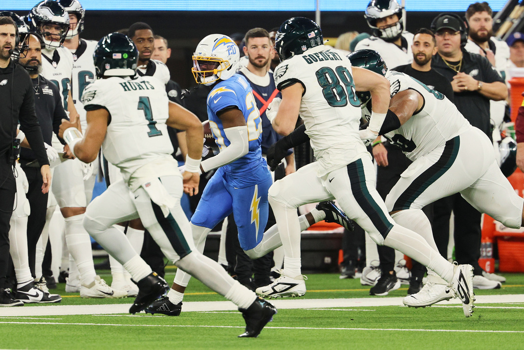 Los Angeles Chargers cornerback Cam Hart (20) runs back with an intercepted pass during the second half of an NFL football game against the Philadelphia Eagles, Monday, Dec. 8, 2025, in Inglewood, Calif. (AP Photo/Kevork Djansezian)