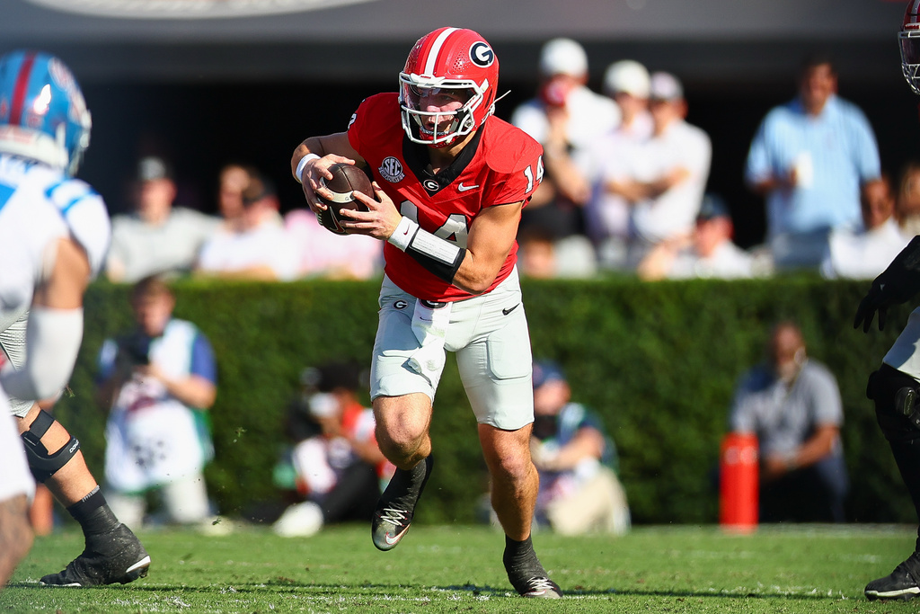 Georgia quarterback Gunner Stockton (14) runs with the ball during the first half of an NCAA college football game against Mississippi, Saturday, Oct. 18, 2025, in Athens, Ga. (AP Photo/Colin Hubbard)