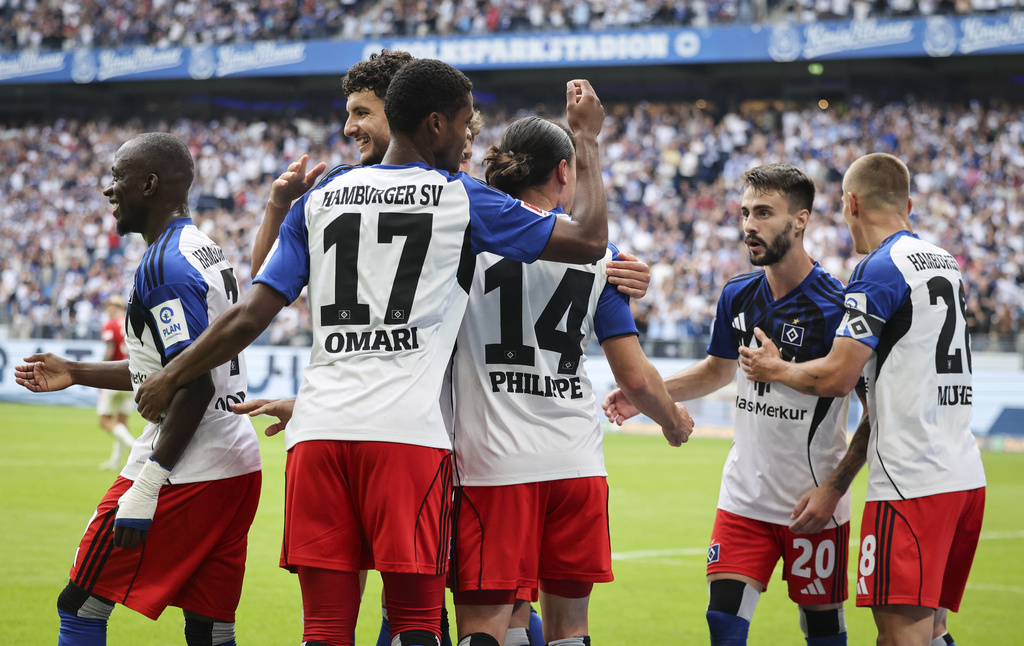 Hamburger SV's Rayan Philippe, third right, celebrates scoring their side's second goal of the game during the German Bundesliga soccer match between Hamburger SV and Heidenheim at Volksparkstadion in Hamburg, Germany, Saturday, Sept. 20, 2025. (Christian Charisius/dpa via AP)