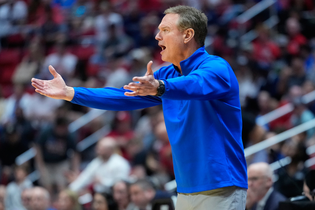 FILE - Kansas head coach Bill Self motions towards the court during the first half of a game between Kansas and St. John's in the second round of the NCAA college basketball tournament Sunday, March 22, 2026, in San Diego. (AP Photo/Mark J. Terrill, File)