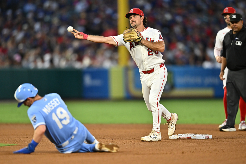 Los Angeles Angels second baseman Adam Frazier, center, throws for a double play after forcing out Kansas City Royals' Michael Massey during the fifth inning of a baseball game Saturday, Aug. 15, 2026, in Anaheim, Calif. (AP Photo/William Liang)