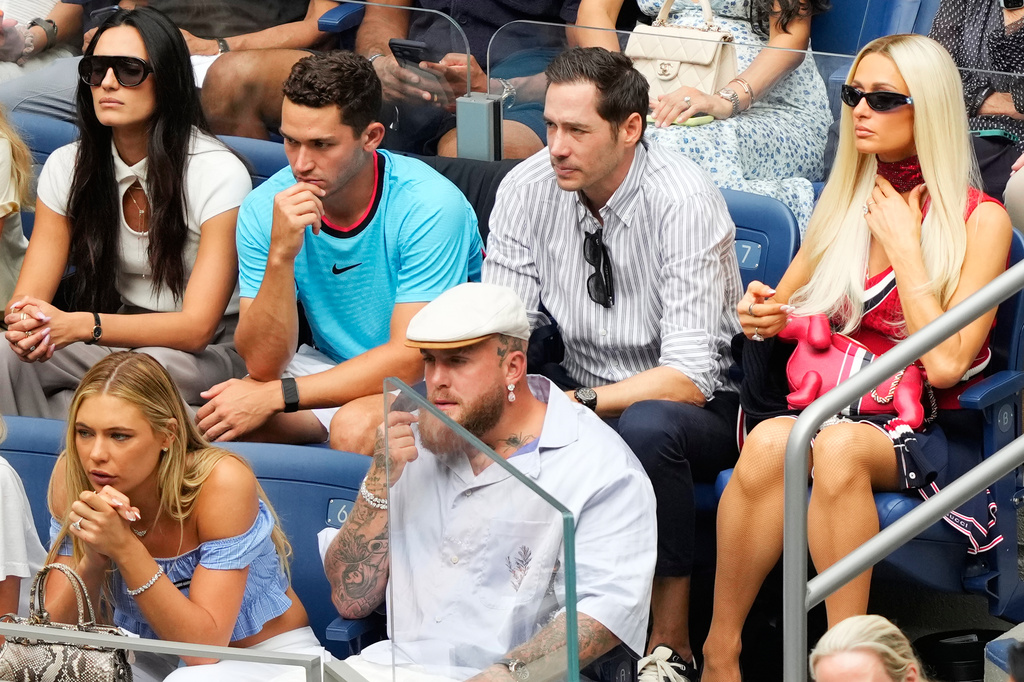 Paris Hilton, second row right, Jutta Leerdam, from left, and Jake Paul, front right, attend a match between Aryna Sabalenka, of Belarus, and Elena Rybakina, of Kazakhstan, during the women's singles final of the U.S. Open tennis championships Saturday, Sept. 12, 2026, in New York. (AP Photo/Yuki Iwamura)