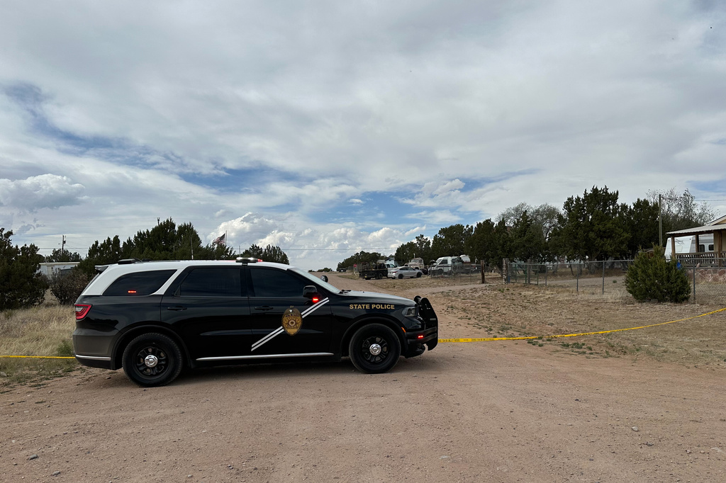 A New Mexico State Police vehicle blocks off a neighborhood in Mountainair, N.M., where authorities say several people died Wednesday, May 20, 2026, and more than a dozen first responders were exposed to an unknown substance and later treated at a hospital. (AP Photo/Savannah Peters)