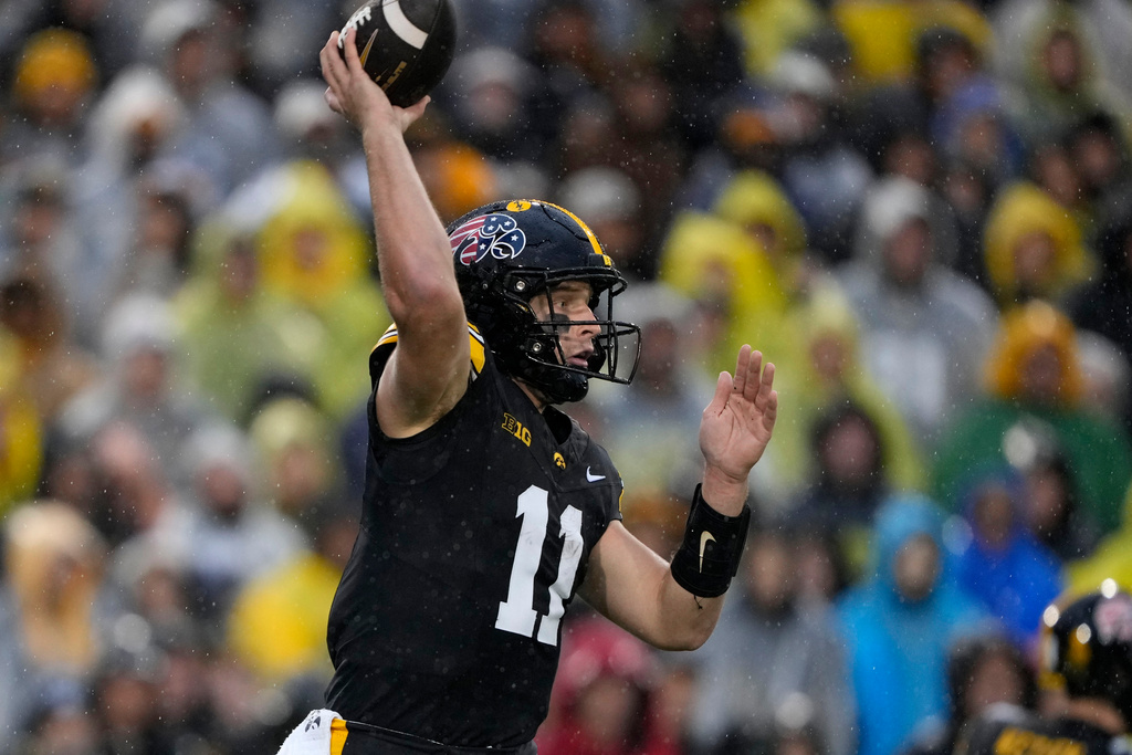 Iowa quarterback Mark Gronowski throws a pass during the first half of an NCAA college football game against Oregon, Saturday, Nov. 8, 2025, in Iowa City, Iowa. (AP Photo/Charlie Neibergall)