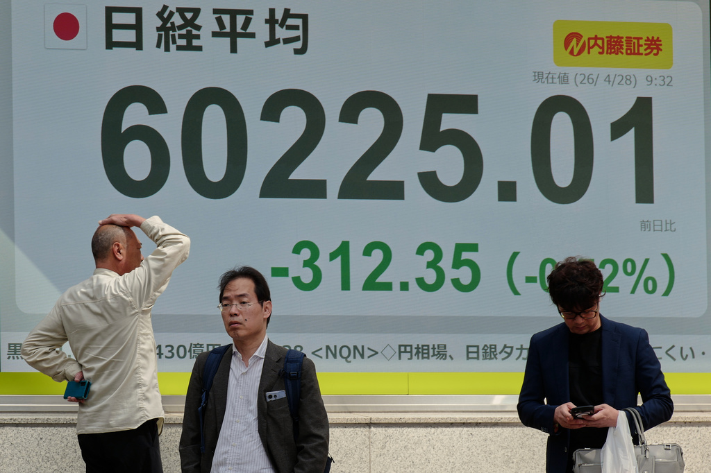 A person looks at an electronic stock board showing Japan's Nikkei index at a securities firm, Tuesday, April 28, 2026, in Tokyo. (AP Photo/Eugene Hoshiko)