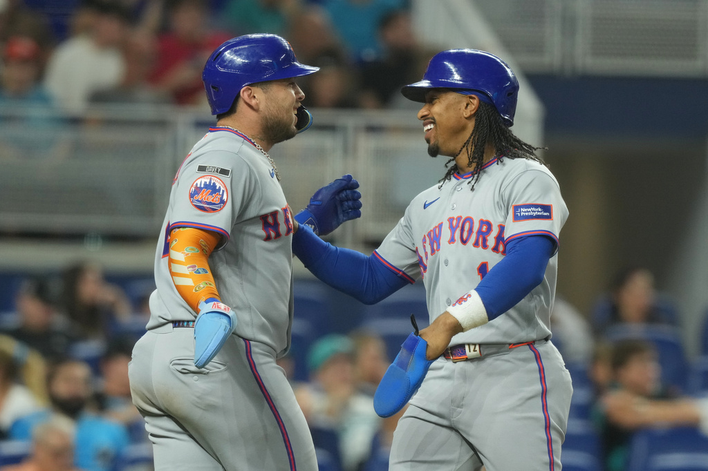 New York Mets' Francisco Alvarez, left, and Francisco Lindor (12) celebrate after scoring on a three-run home run by Juan Soto during the second inning of a baseball game against the Miami Marlins Tuesday, Sept. 8, 2026, in Miami. (AP Photo/Marta Lavandier)