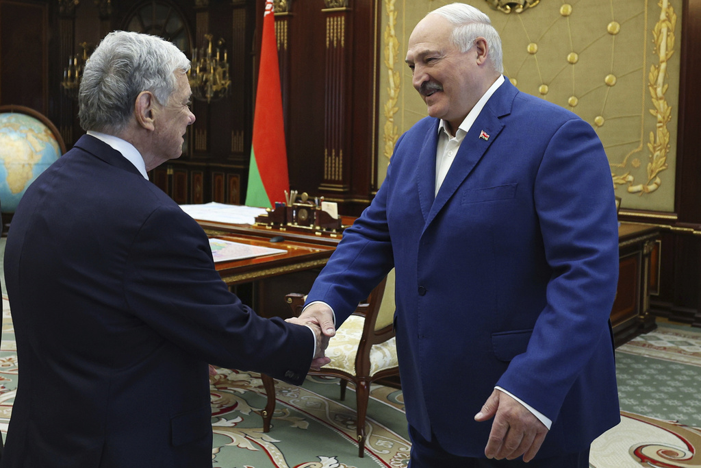 In this photo released by Belarusian presidential press service, Belarusian President Alexander Lukashenko, right, and U.S. Presidential envoy John Coale shake hands during their meeting in Minsk, Belarus, Thursday, Sept. 11, 2025. (Belarusian Presidential Press Service via AP)