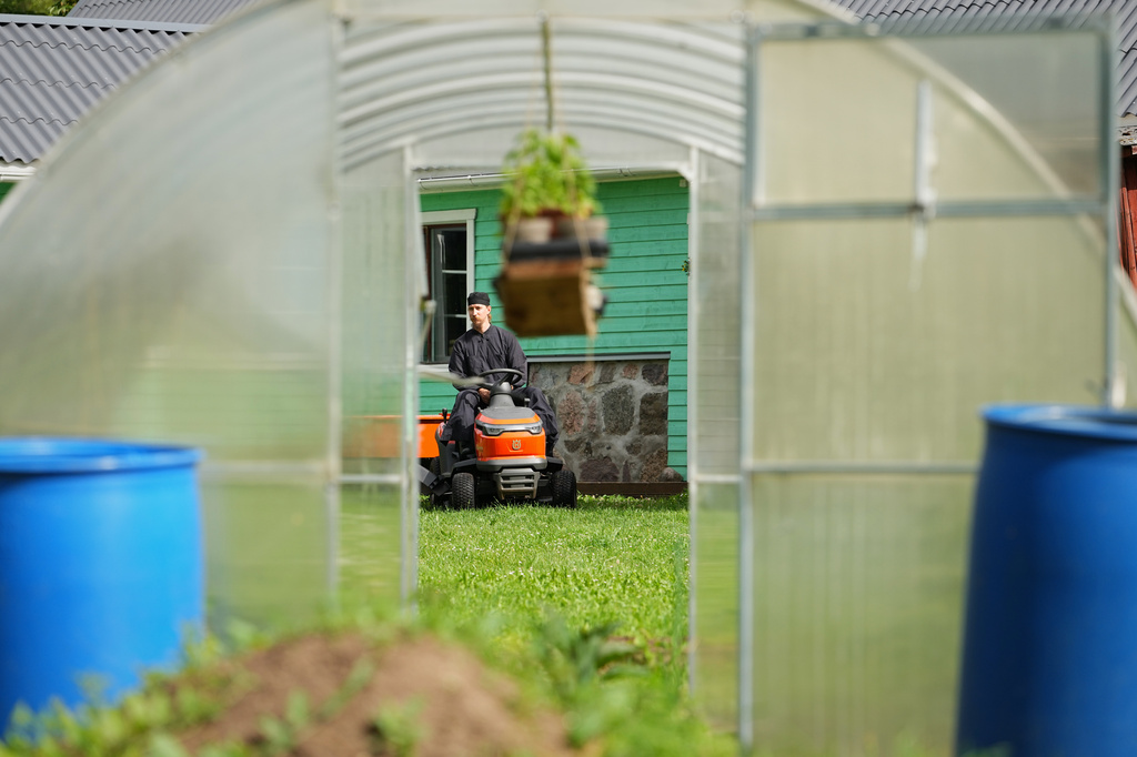 Estonia Monastery Rev. Paisios drives a riding lawn mower at the newly founded Kirikla Orthodox Monastery in Pihali village, Estonia, on July 4, 2026. (AP Photo/Sergei Grits)