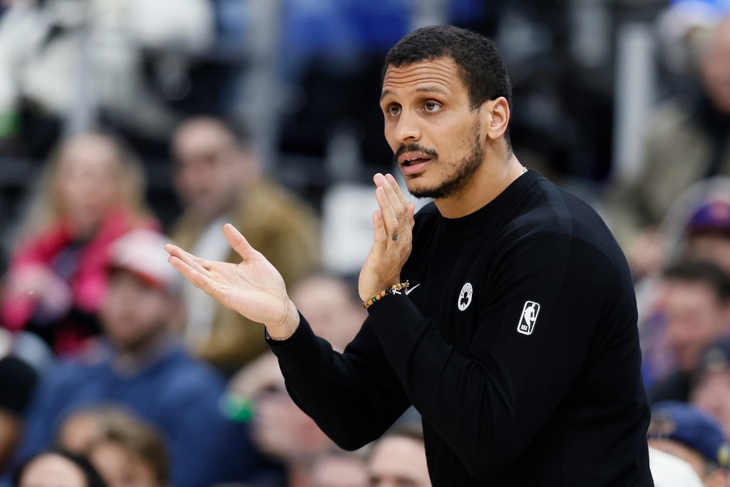 Boston Celtics head coach Joe Mazzulla applauds his team during a timeout against the Detroit Pistons during the first half of an NBA basketball game Monday, Jan. 19, 2026, in Detroit. (AP Photo/Duane Burleson)