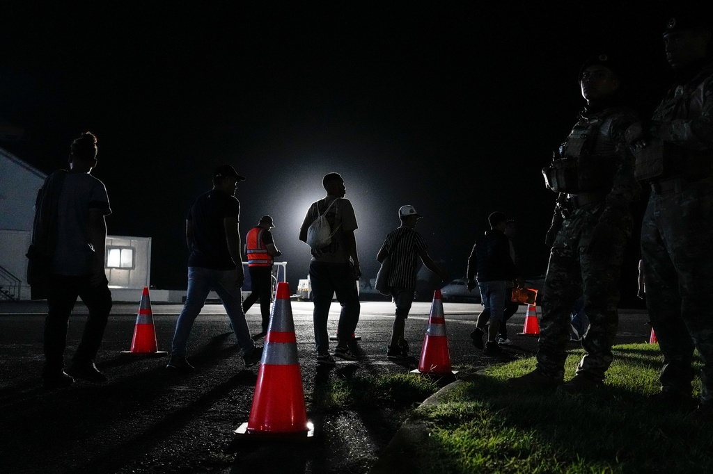 Venezuelan migrants walk to board a voluntary repatriation flight to their country at the International Airport in Panama Pacifico, Panama, Friday, May 22, 2026. (AP Photo/Matias Delacroix)