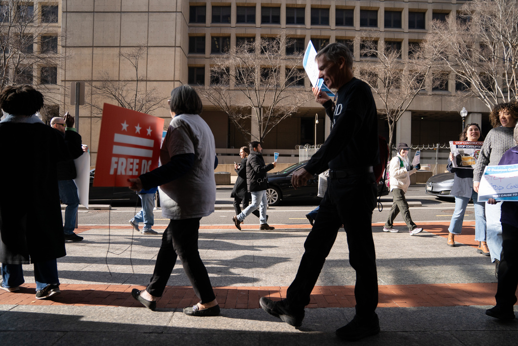 Protesters opposed to the White House ballroom project hold signs and chant outside of a National Capitol Planning Commission meeting discussing the project, Thursday, Jan. 8, 2026, in Washington. (AP Photo/Allison Robbert)