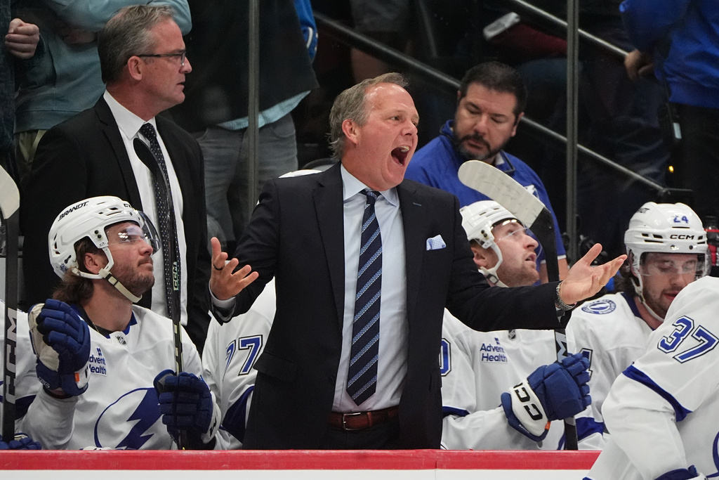 Tampa Bay Lightning head coach Jon Cooper, center, reacts to referees in the second period of an NHL hockey game against the Colorado Avalanche, Tuesday, Nov. 4, 2025, in Denver. (AP Photo/David Zalubowski)