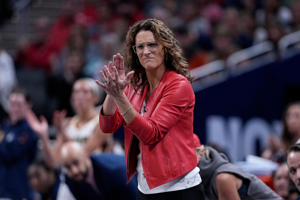 Indiana Fever head coach Stephanie White cheers as the Indiana Fever plays the New York Liberty in the first half of a WNBA basketball game in Indianapolis, Tuesday, Aug. 11, 2026. (AP Photo/Michael Conroy)