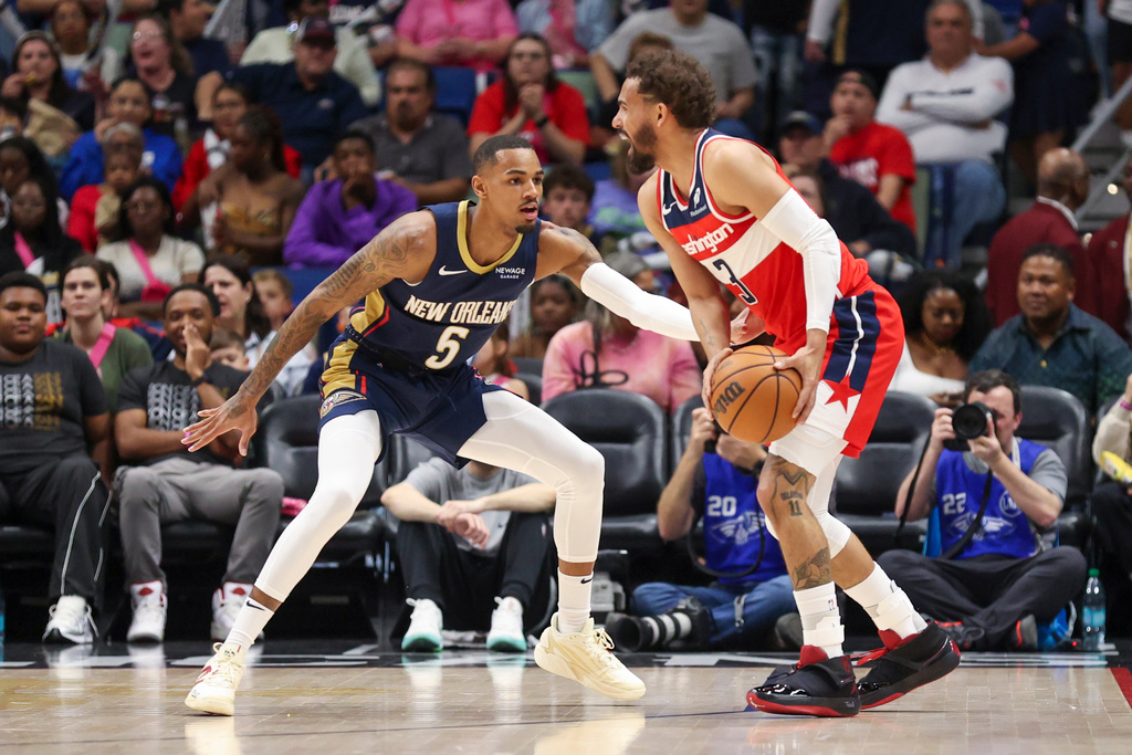 Washington Wizards guard Trae Young (3) tries to make a move against New Orleans Pelicans guard Dejounte Murray (5) in the first half of an NBA basketball game in New Orleans, Sunday, March 8, 2026. (AP Photo/Peter Forest)