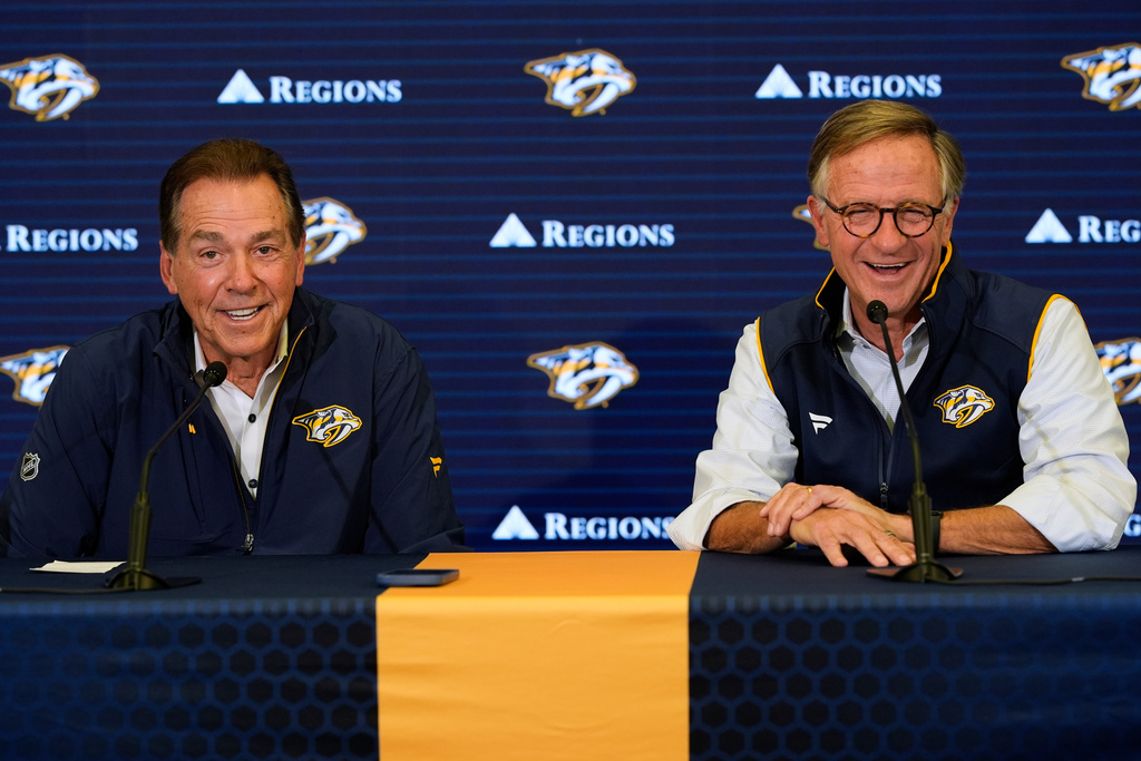 Nick Saban, left, and Nashville Predators majority owner Bill Haslam, right, speak during a news conference announcing Saban's minority ownership of the NHL hockey team Monday, Dec. 22, 2025, in Nashville, Tenn. (AP Photo/George Walker IV)
