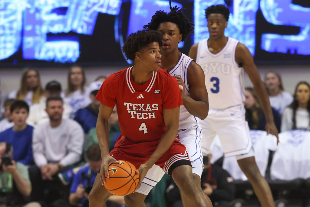 Texas Tech guard Christian Anderson (4) posts up against BYU guard Robert Wright III, center right, during the first half of an NCAA college basketball game, Saturday, March 7, 2026, in Provo, Utah. (AP Photo/Rob Gray)