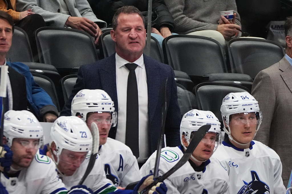 Vancouver Canucks head coach Adam Foote looks on form the team box in the second period of an NHL hockey game against the Colorado Avalanche Tuesday, Dec. 2, 2025, in Denver. (AP Photo/David Zalubowski)