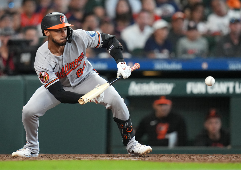 Baltimore Orioles' Jeremiah Jackson hits a sacrifice bunt to score a run during the tenth inning of a baseball game against the Houston Astros, Saturday, July 18, 2026, in Houston. (AP Photo/Karen Warren)
