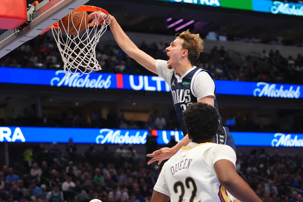 Dallas Mavericks forward Cooper Flagg (32) dunks against New Orleans Pelicans center Derik Queen (22) during the second half of an NBA Cup basketball game in Dallas, Friday, Nov. 21, 2025. (AP Photo/LM Otero)