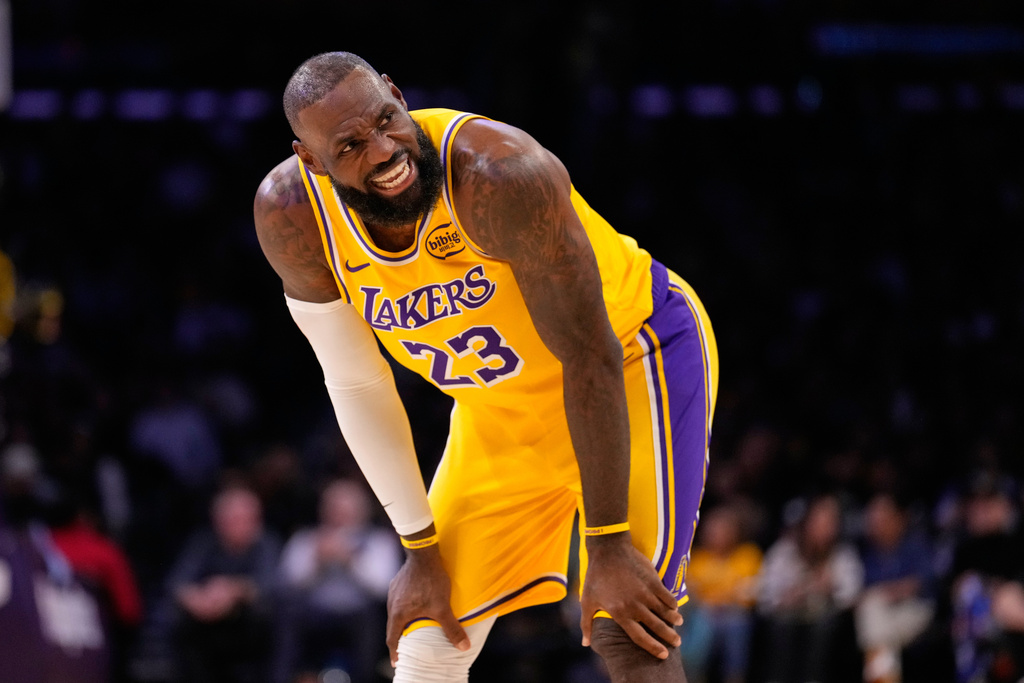 Los Angeles Lakers forward LeBron James talks to a referee during the first half of an NBA basketball game against the Phoenix Suns, Monday, Dec. 1, 2025, in Los Angeles. (AP Photo/Mark J. Terrill)
