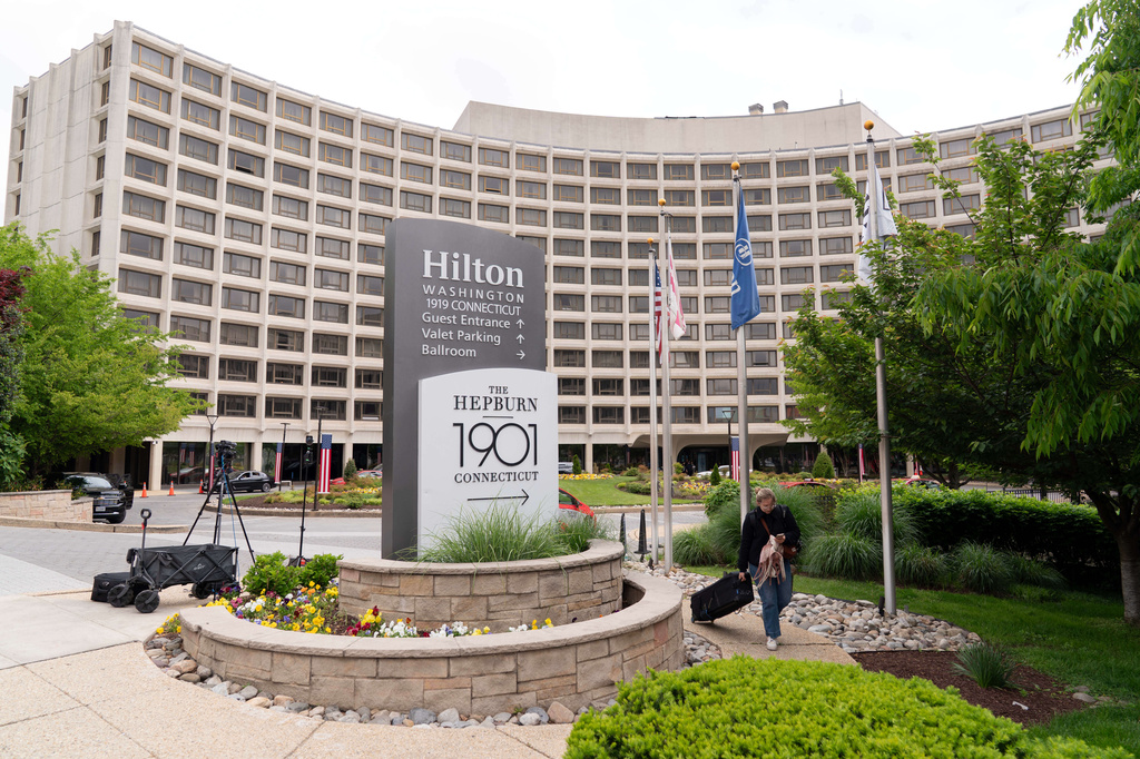 A person walks outside of the Washington Hilton Hotel, Sunday, April, 26, 2026, in Washington, the day after a gunman tried to storm into the hotel's ballroom during the White House Correspondents’ Dinner. (AP Photo/Jose Luis Magana)