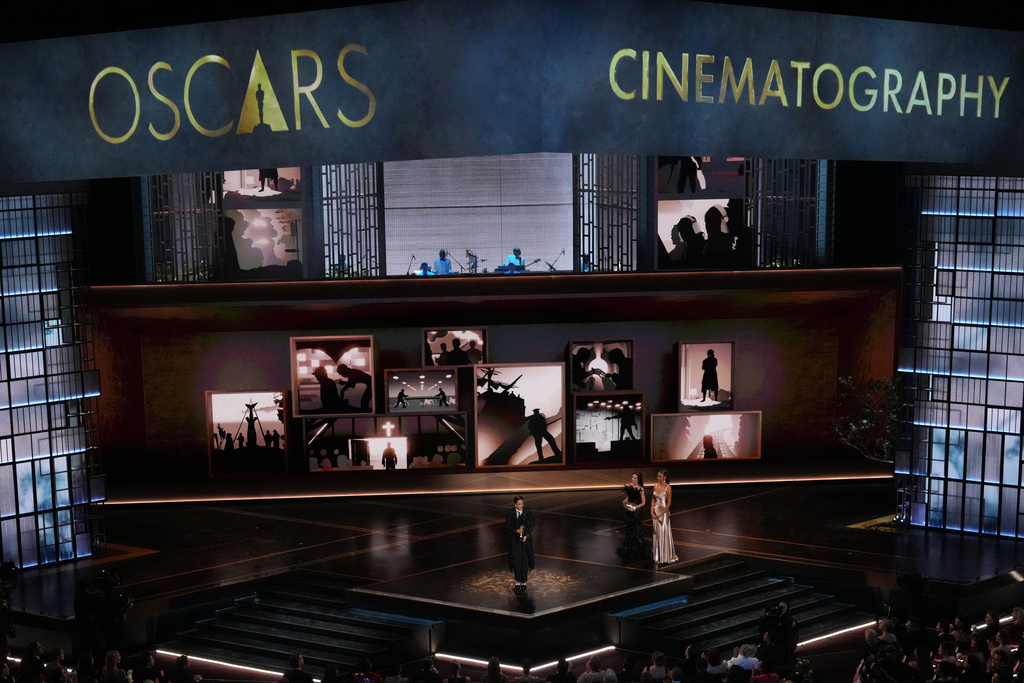 Autumn Durald Arkapaw accepts the award for cinematography for "Sinners" during the Oscars on Sunday, March 15, 2026, at the Dolby Theatre in Los Angeles. Demi Moore looks on from right. (AP Photo/Chris Pizzello)