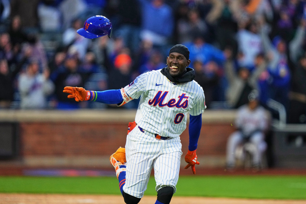 New York Mets' Ronny Mauricio (0) celebrates after hitting a game winning walk-off single during the tenth inning of a baseball game against the Arizona Diamondbacks Tuesday, April 7, 2026, in New York. (AP Photo/Frank Franklin II)