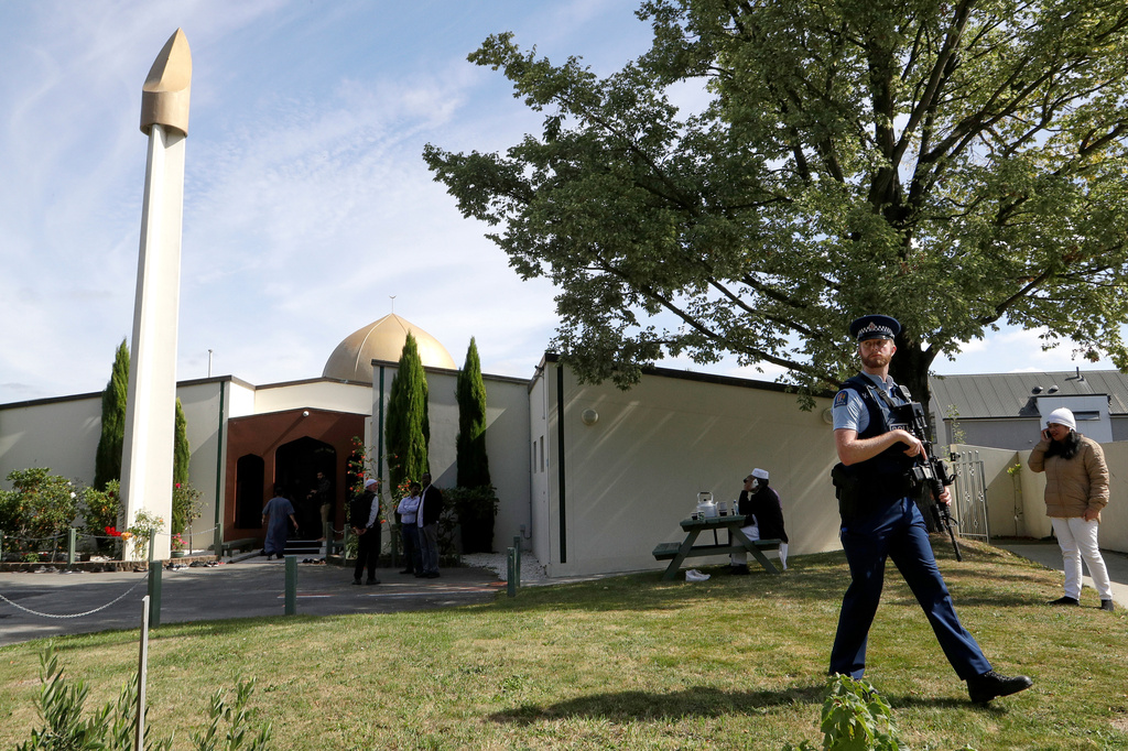 FILE - An armed policeman patrols the grounds at the Al Noor mosque following the previous week's mass shooting in Christchurch, New Zealand, on March 23, 2019. (AP Photo/Mark Baker, File)