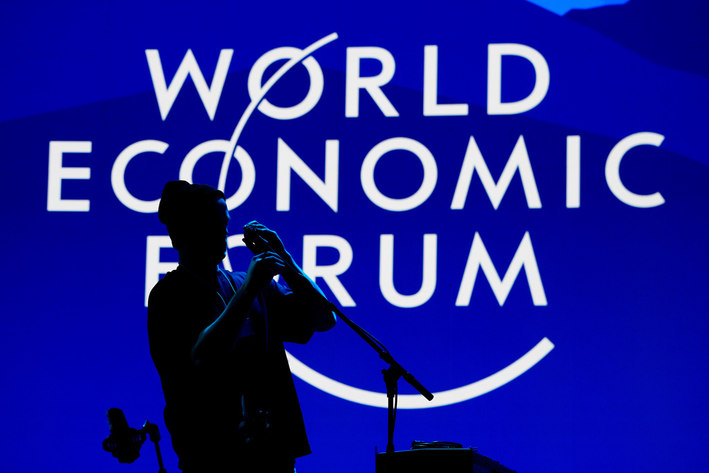 A man installs a microphone for the opening concert of the Annnual Meeting of the World Economy Forum at the Congress Center in Davos, Switzerland, Sunday, Jan. 18, 2026. (AP Photo/Markus Schreiber)