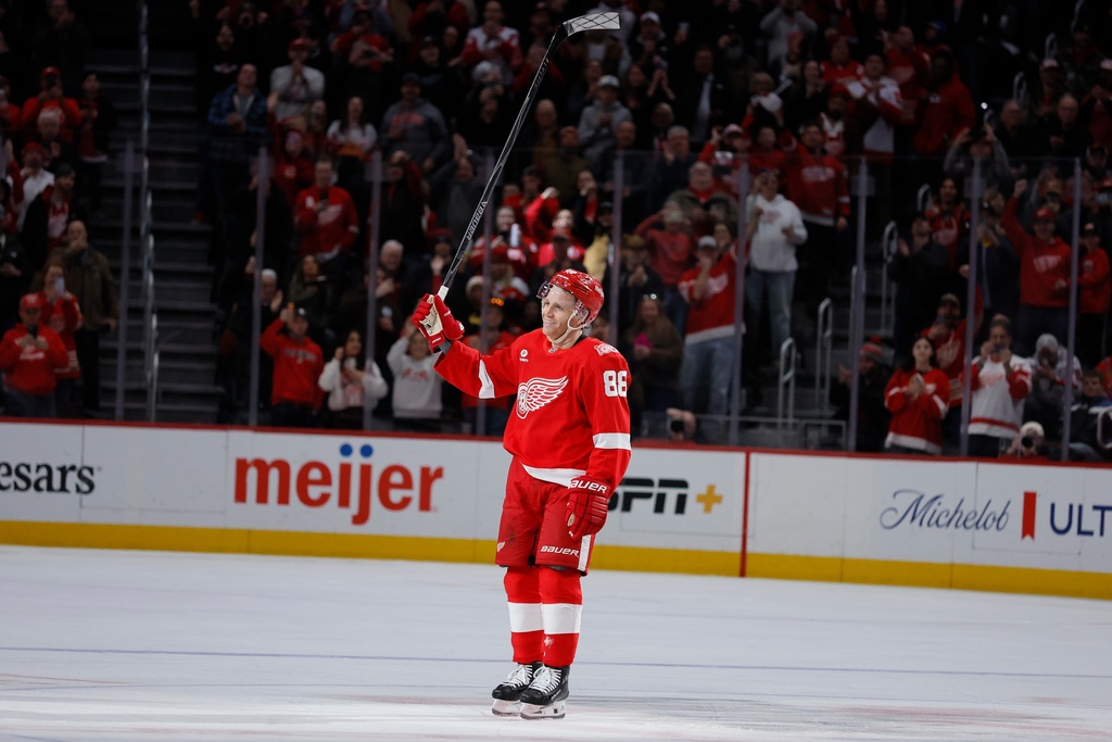 Detroit Red Wings right wing Patrick Kane acknowleges the fans after recording his 1,375th point to pass Mike Modano and break the NHL record for points by a player born in the United States, during the second period of an NHL hockey game Thursday, Jan. 29, 2026, in Detroit. Kane assisted on a goal by defenseman Ben Chiarot to break the record. (AP Photo/Duane Burleson)