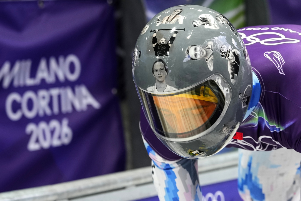 Ukraine's Vladyslav Heraskevych arrives at the finish during a men's skeleton training session at the 2026 Winter Olympics, in Cortina d'Ampezzo, Italy, Tuesday, Feb. 10, 2026. (AP Photo/Alessandra Tarantino)