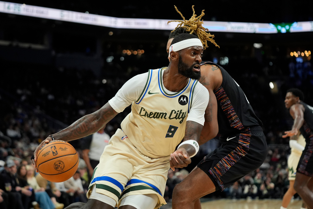 Milwaukee Bucks' Bobby Portis (9) drives to the basket against Brooklyn Nets' Noah Clowney during the first half of an NBA basketball game, Saturday, Nov. 29, 2025, in Milwaukee. (AP Photo/Aaron Gash)