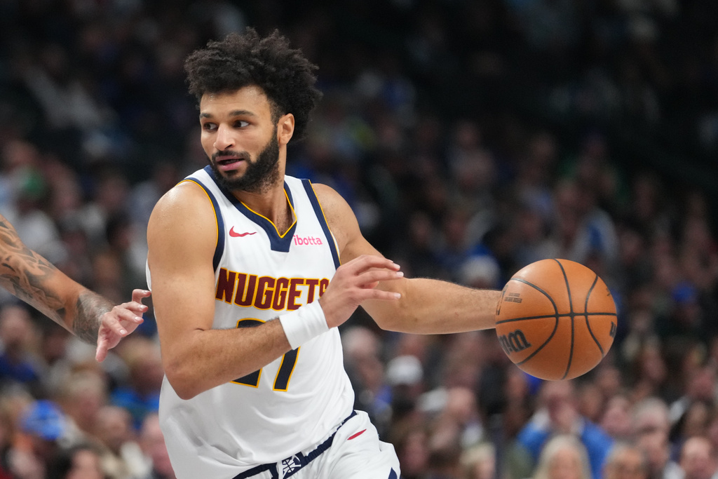 Denver Nuggets guard Jamal Murray drives to the basket against the Dallas Mavericks during the first half of an NBA basketball game Wednesday, Jan. 14, 2026, in Dallas. (AP Photo/Julio Cortez)
