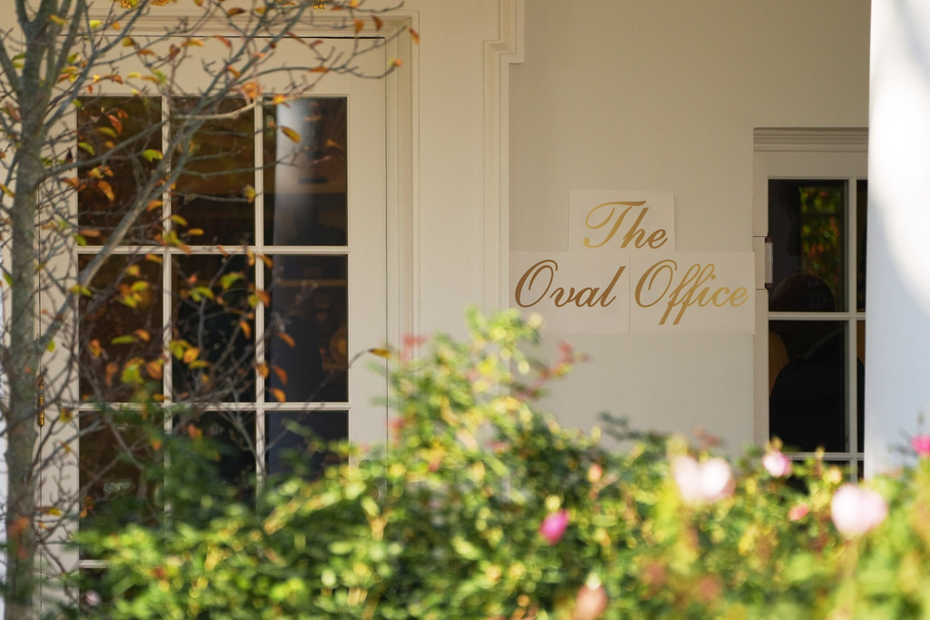 A sign is seen outside the Oval Office before President Donald Trump walks out to board Marine One on the South Lawn of the White House, Wednesday, Nov. 5, 2025, in Washington. (AP Photo/Evan Vucci)