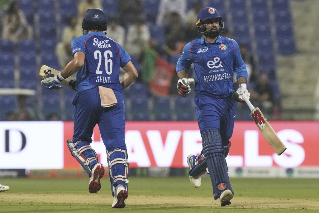 Afghanistan's Sediqullah Atal, left and Afghanistan's Mohammad Nabi run between the wickets to score during the Asia Cup Cricket match between Afghanistan and Hong Kong at Zayed Cricket Stadium in Abu Dhabi, United Arab Emirates, Tuesday, Sept. 9, 2025. (AP Photo/Fatima Shbair)
