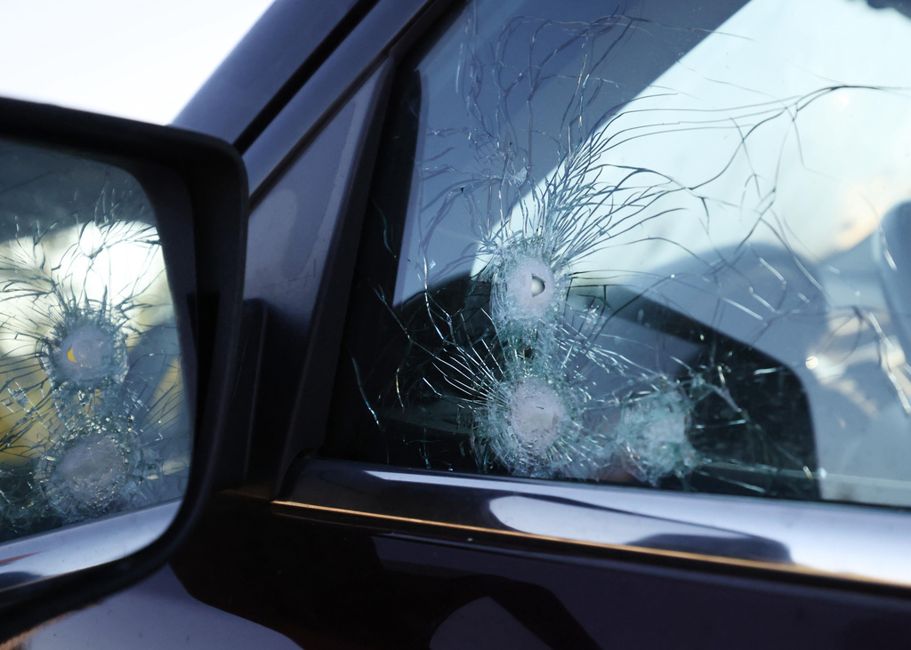 Bullet holes are seen on a crossover utility vehicle parked near the Church of Jesus Christ of Latter-day Saints, Monday, Sept. 29, 2025 in Grand Blanc Township, Mich. (AP Photo/Carlos Osorio)