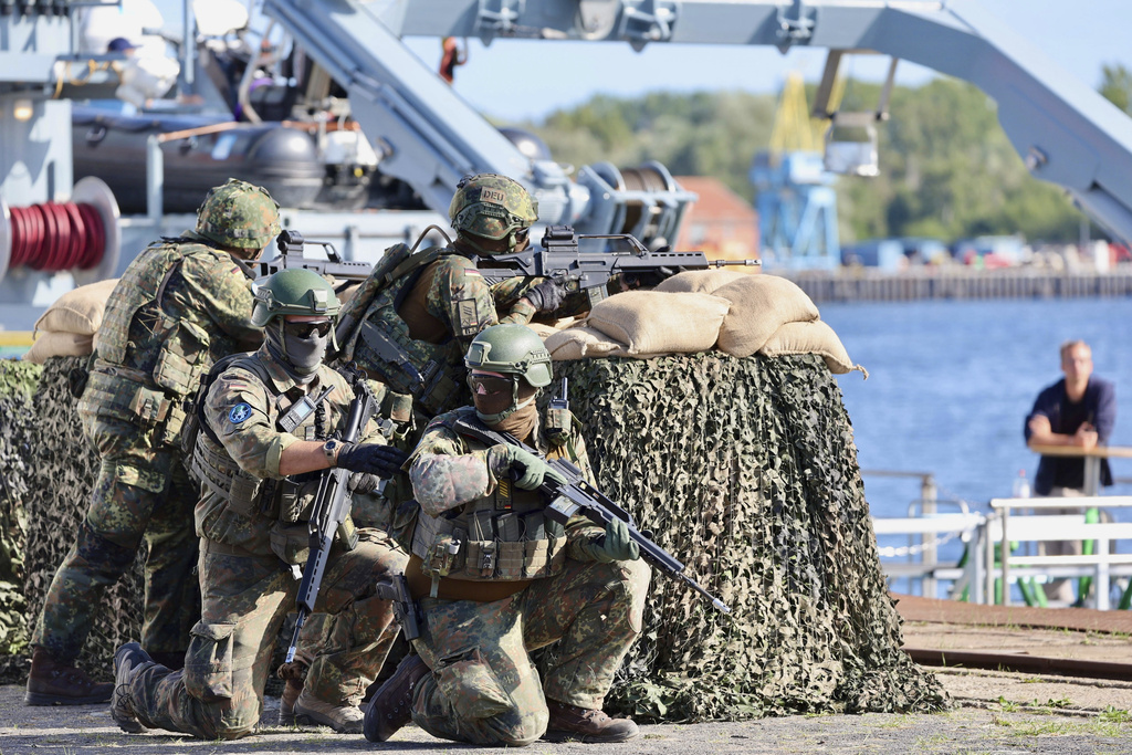 Soldiers of the German forces, Bundeswehr, secure the port at the start of Media Day as part of the 'Quadriga 2025' military maneuver in Rostock, Germany, Thursday, Sept. 4, 2025. (Jens Buettner/dpa via AP)